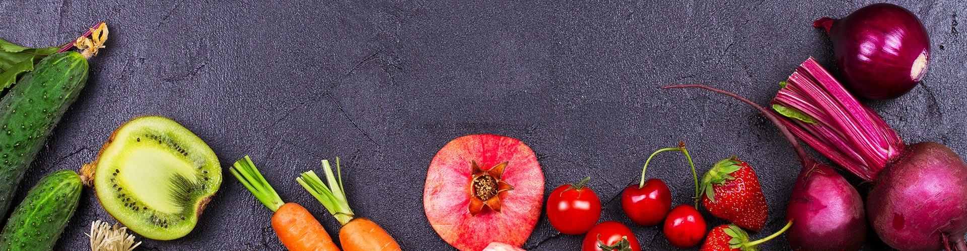 Verschiedenes Obst und Gemüse auf dunklem Hintergrund